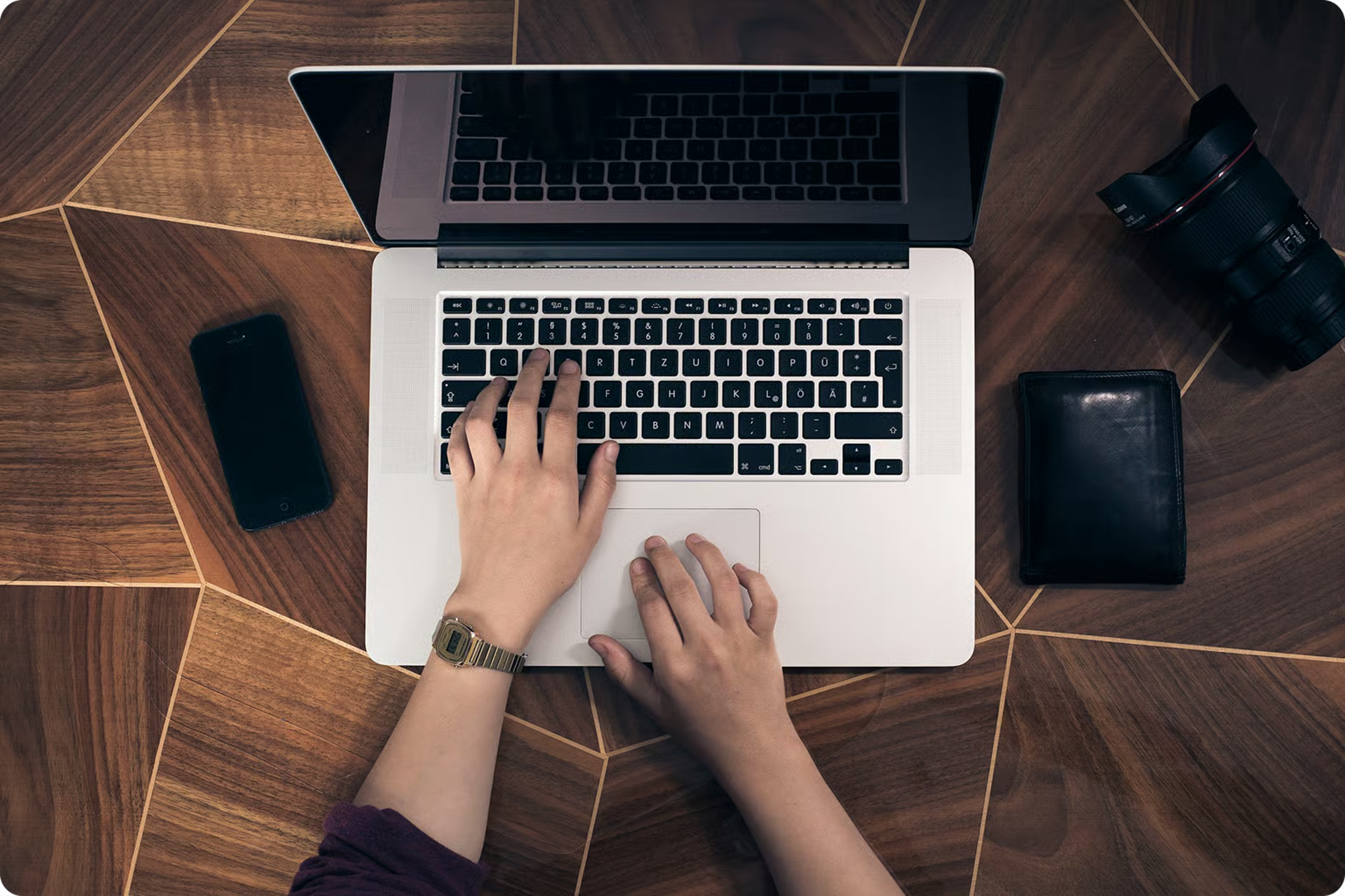 A Principal at a desk with laptop and phone, preparing for the week.
